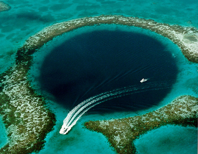 Aerial view of the Great Blue Hole Photo Credit: U.S. Geological Survey (USGS) - Source: [1], fetched September 2006. Caption on this USGS web page was, "Blue Hole: Aerial view of the 400-ft-deep oceanic blue hole (Lighthouse Reef Atoll Blue Hole) located east of Belize.", Public Domain, https://commons.wikimedia.org/w/index.php?curid=1813649