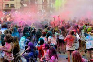 Celebrants of Holi fling colors on each other