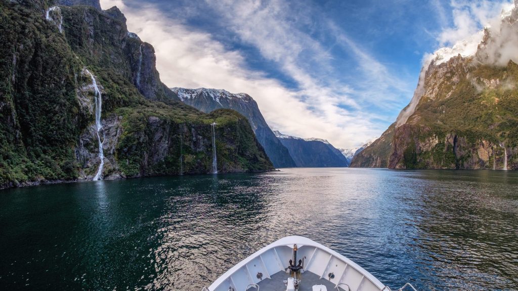 looking out at Milford Sound's waterfalls from bow of boat