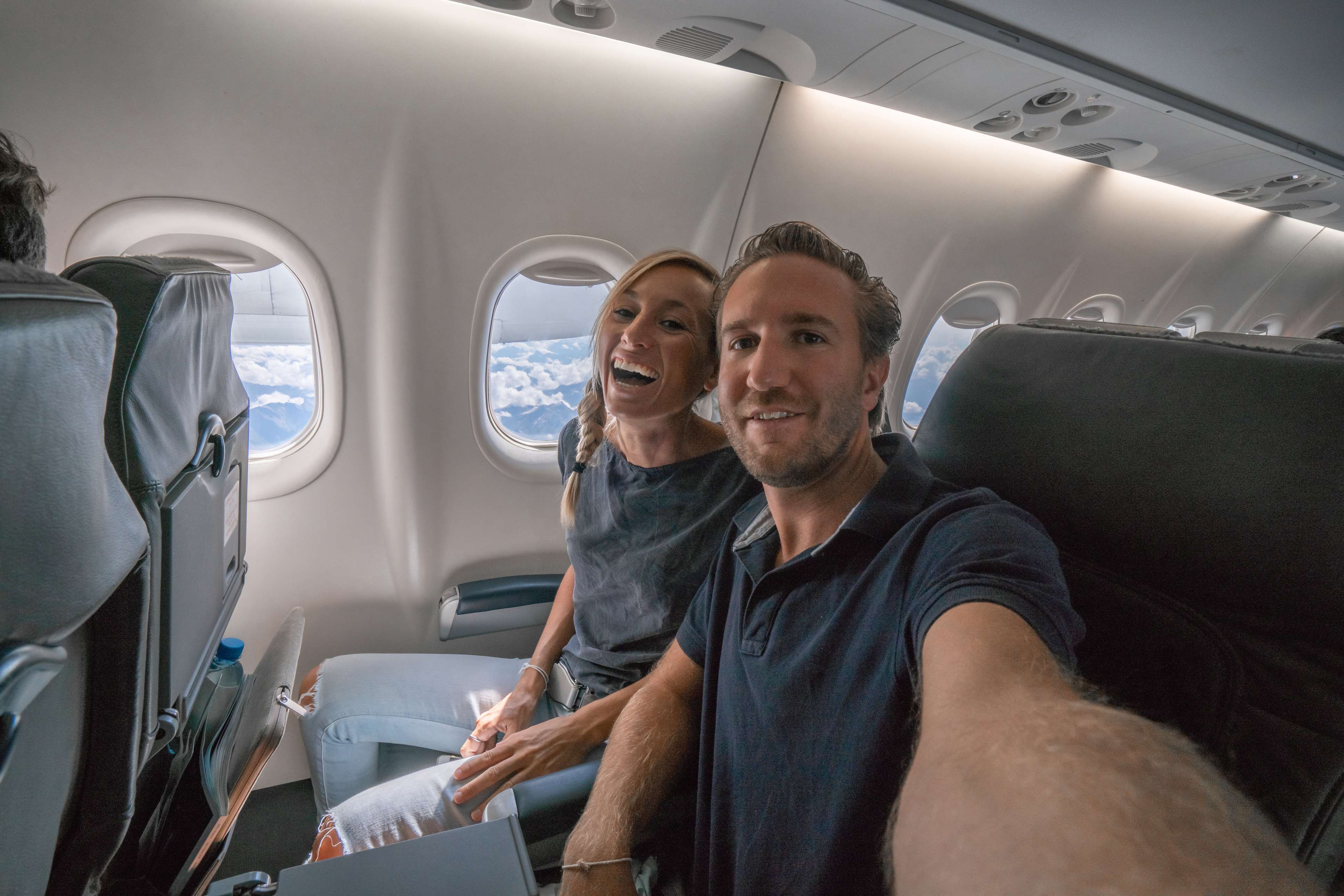 couple taking a selfie from plane seat