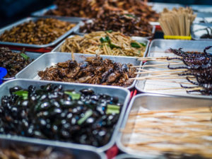 Deep Fried edible insects on the streets of Khao San Road in Bangkok, Thailand, where locals love bugs on the menu.