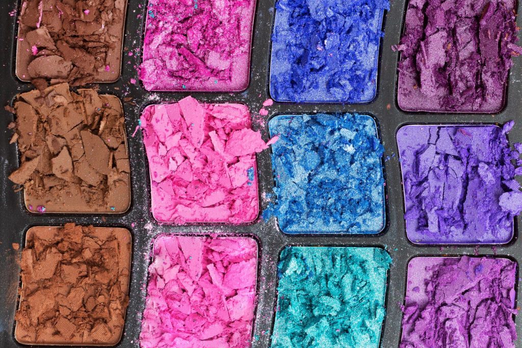 pallet of bright colored eyeshadow is broken because the traveler didn't listen to Jaya Travel best tips for traveling with makeup.