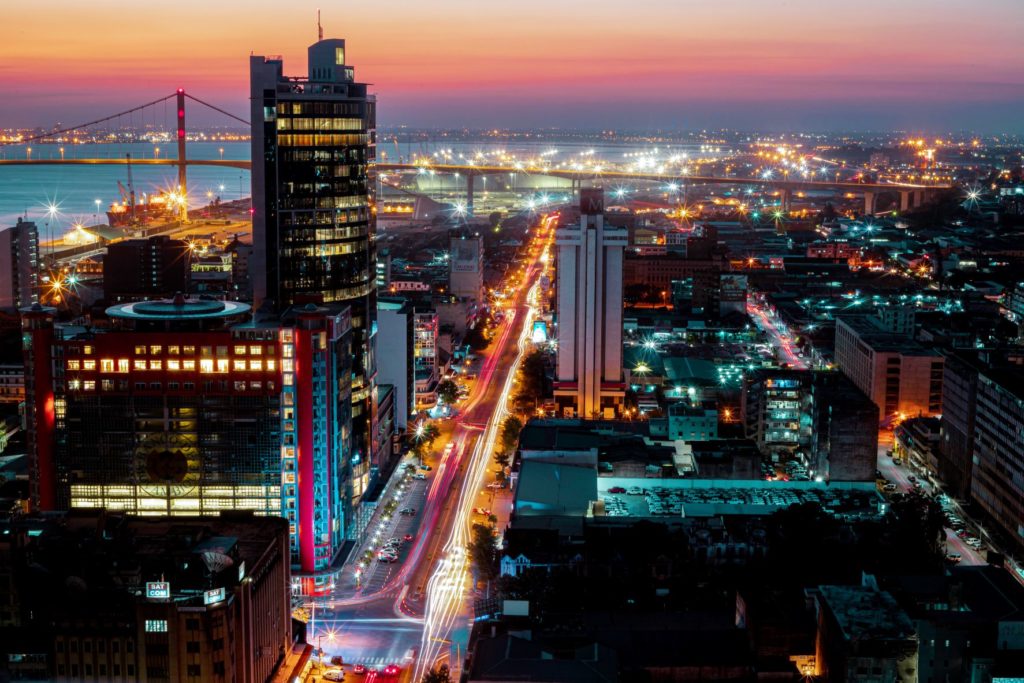 An aerial view over the city of Maputo in Mozambique, Africa with bright lights, tall buildings, and a waterside view where ever you travel.