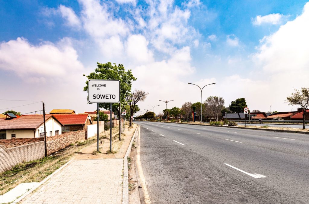 A white street sign says welcome to the soweto South Africa, where Jaya Travel tours the movie location of District 9.