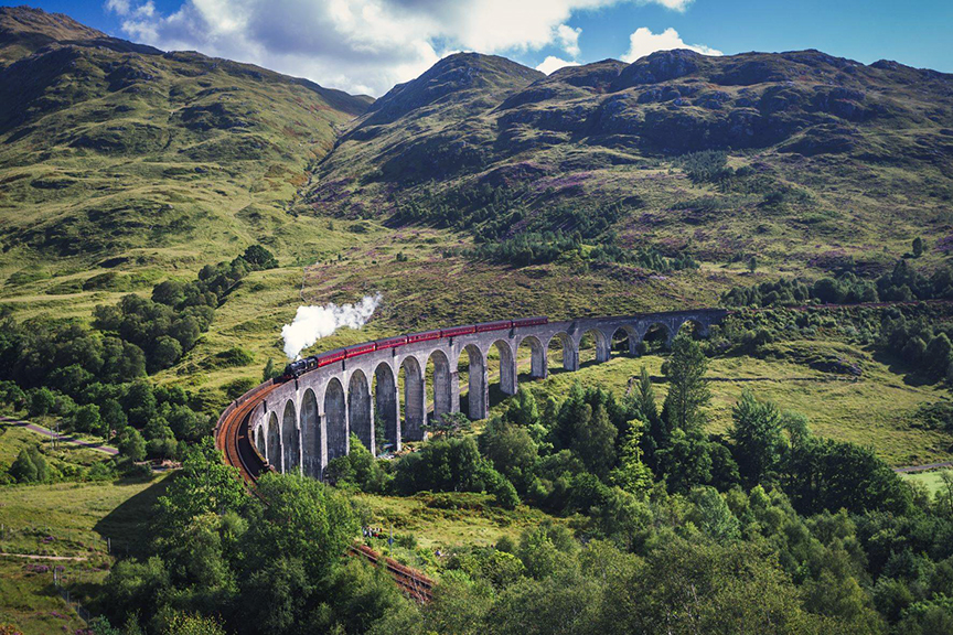 Travel the route of the Hogwarts Express from the Harry Potter movie series on the Jacobite steam train tours over Glenfinnan Viaduct from Fort William to Mallaig in Scotland.