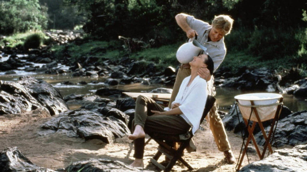 Denys Finch Hatton, as Robert Redford, shampoos Karen Blixen, Meryl Streep, hair while standing on the banks of a river in the movie locations of Out Of Africa.
