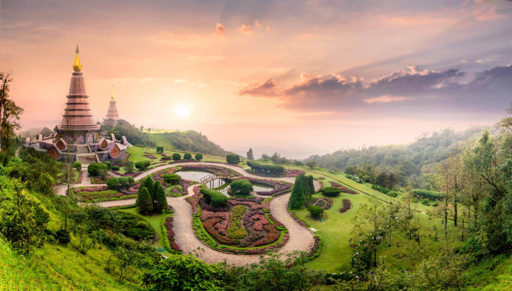 Tour Thailand and the landmark pagoda, wooden bridge, flower garden, and temple in Doi Inthanon National Park with mist during sunset at Chiang mai, Thailand with Jaya.