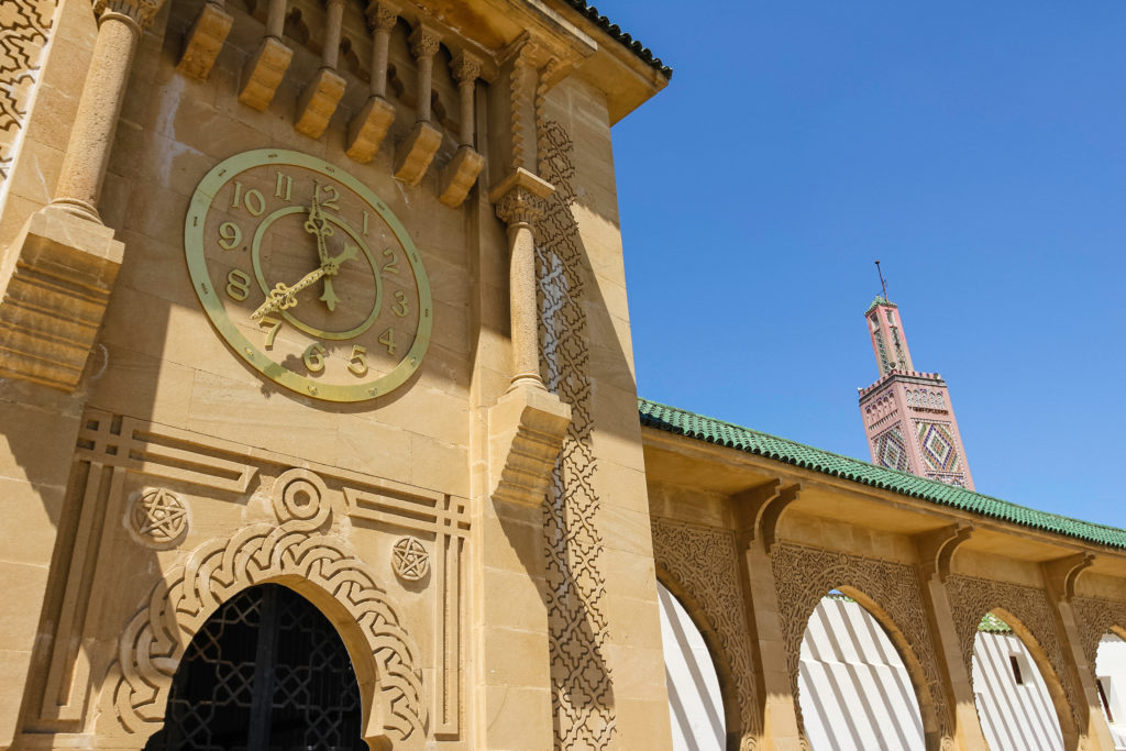 The grand souk is a beige stone building in Mombasa with a clock and beautiful architecture in the city of tangier which was used as an inception movie destination.