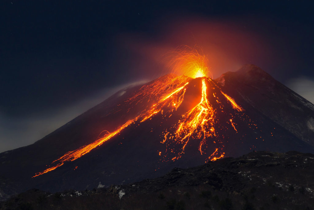 Lava spews out of Mount Etna and magma drips down the sides of the active volcano in Sicily, Italy.