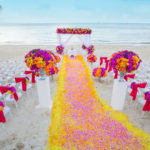 A floral arrangement at a destination wedding ceremony on beach by Jaya Travel & Tours.