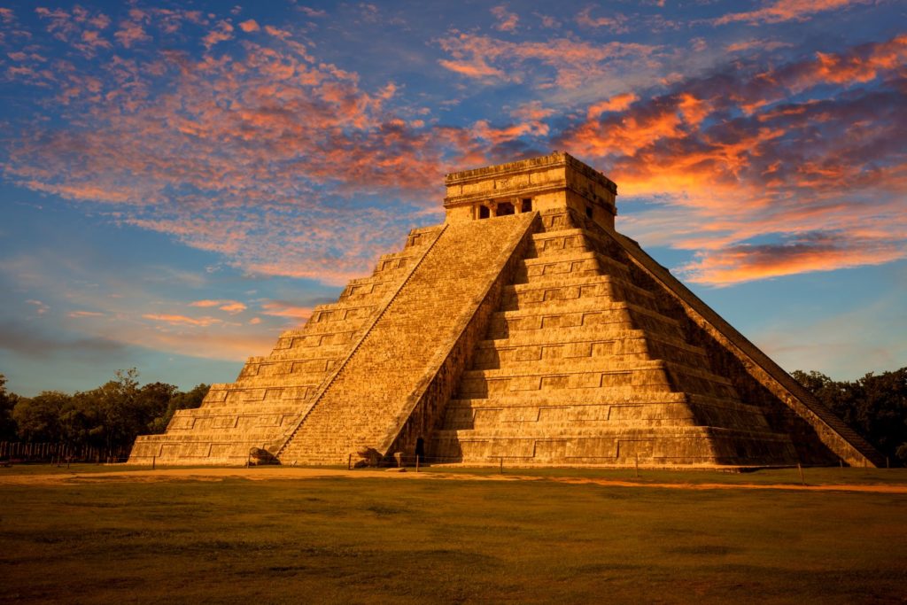 An exterior view of El Castillo, at dusk during a Jaya Travel & Tours vacation to Tinum, Yucatan, Mexico. The Mayan pyramid is the most recognizable feature of Chichen Itza, and one of the 7 wonders of the world.