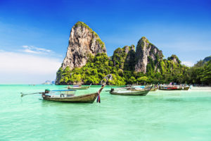 Two longtale boats from a Jaya Travel & Tours Philippines wine vacation of crystal clear waters at El Nido, Palawan, Philippines.