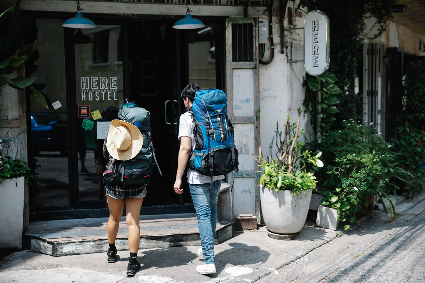 Two travelers walk to their hostel after choosing a hostel with Jaya Travel & Tours.