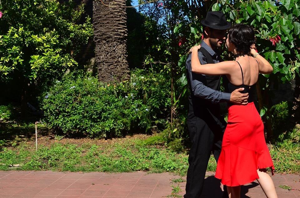 A couple of tourists dance on the sidewalk in the lovely city of Buenos Aires, Argentina this Valentine's Day Honeymoon destination with Jaya Travel & Tours.