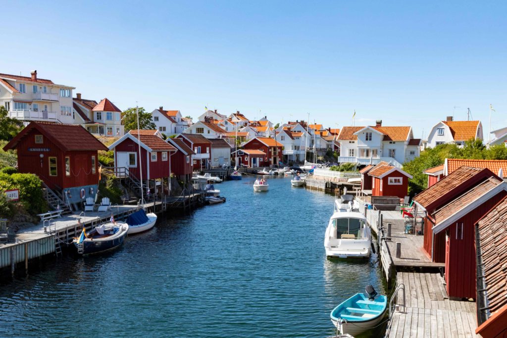 The distant nordic village of Grundsund, in west coast of Sweden. Red and white village houses line a canal road and can be toured with Jaya Travel & Tours.