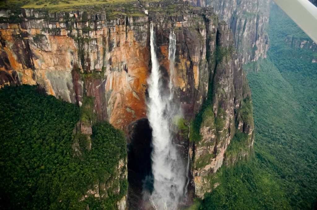 A beautiful falls in Guatemala, with water falling off of a tall rock cliff into a river below. The waterfall is called Angel Falls, and is featured in Jaya Travel & Tours quiz "Which Waterfall Should You Visit Quiz?"