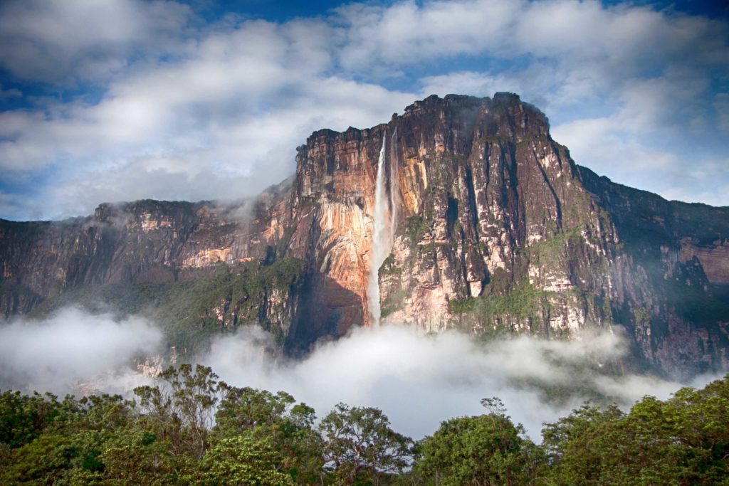 A beautiful long-distance photo of the waterfall Angel Falls in Guatemala, which is surrounded by a forest and river. This is featured in Jaya Travel & Tours blog post about "Which Waterfall You Should Visit Quiz?"