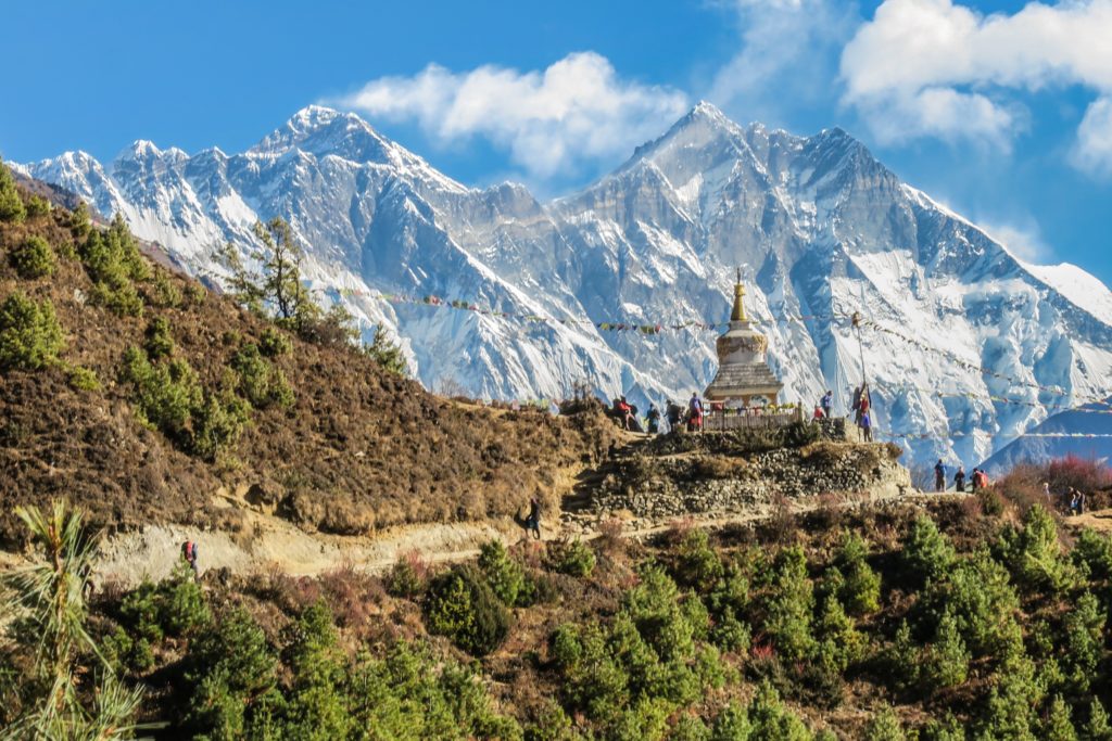 This image of a temple built high in the mountains in Asia is featured in the Jaya travel & tours blog post "Nepal Travel Guide"