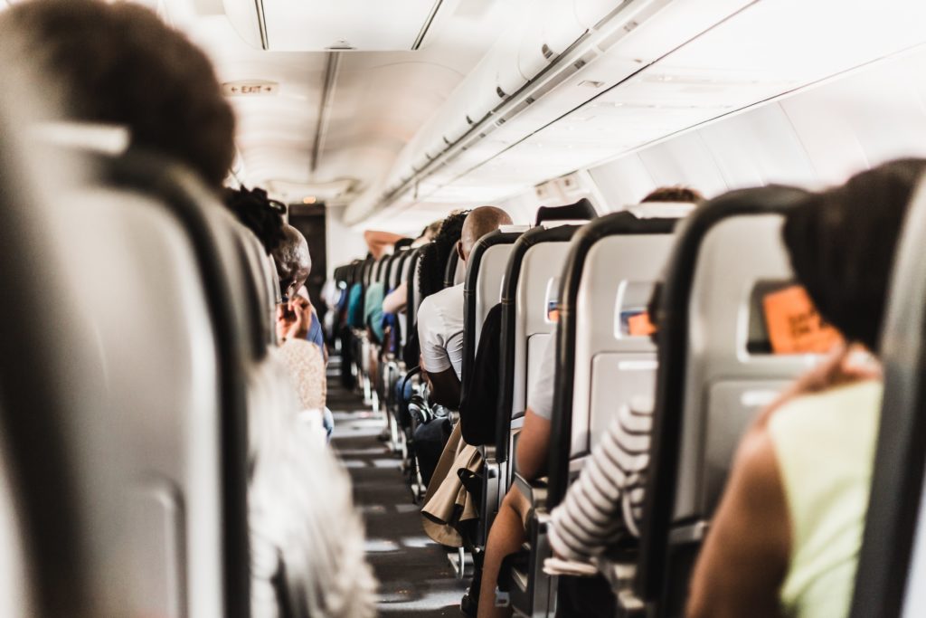 A shot of the interior cabin of an airplane that is full of passengers on the way to their vacations, and they saved money by booking with the best travel agencies like Jaya. This image is featured in the Jaya Travel & Tours blog, "Why You Should Book With Jaya Travel," which describes the benefits and features of booking with Jaya.