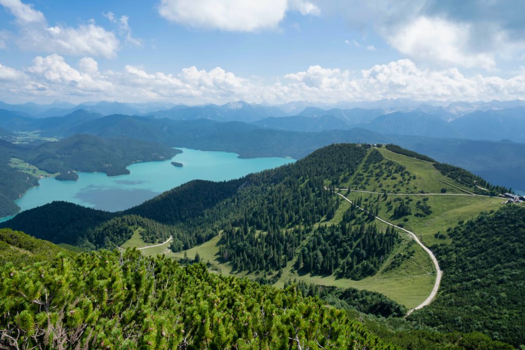 This image of the beautiful landscapes of Bavaria, including forested mountains and bright lakes, is featured in Jaya Travel & Tours' blog post "Bavaria Travel Guide"