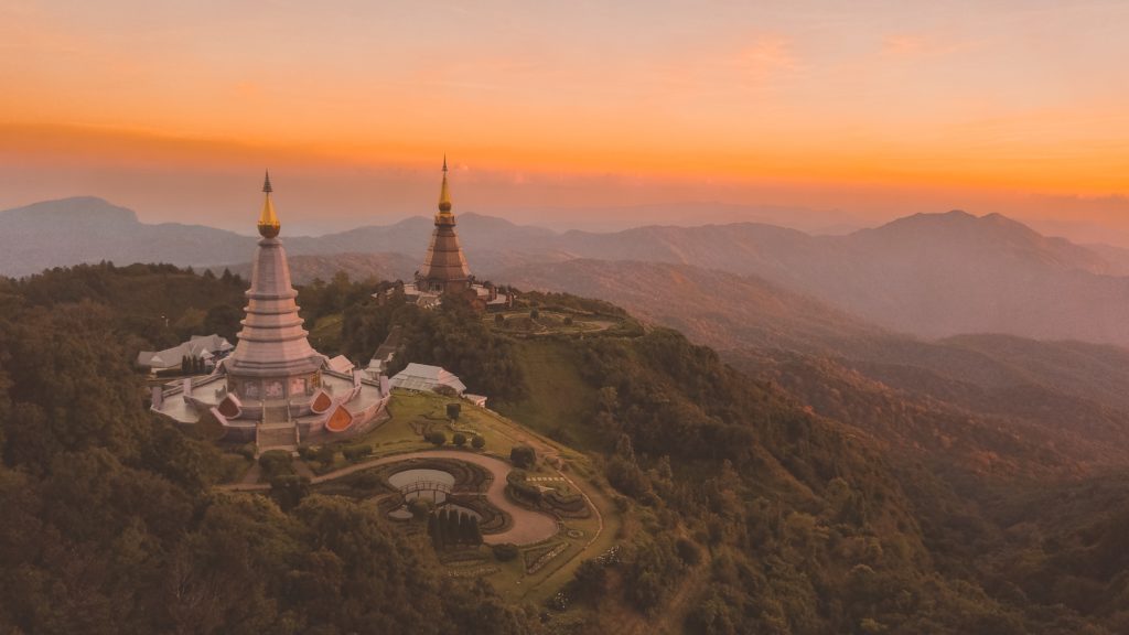 This image of a park in the mountains at sunset is featured in the Jaya Travel & Tours blog post "Thailand Travel Guide"