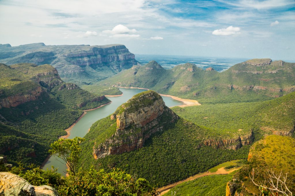 This beautiful landscape shot of South Africa and its various forests, plateaus, and lakes is featured in the Jaya Travel & Tours blog post "Africa Travel Guide"