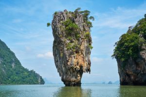 This image of a unique rock formation in Thailand that is floating above the water is featured in Jaya travel & Tours blog post "Asia Travel Guide"