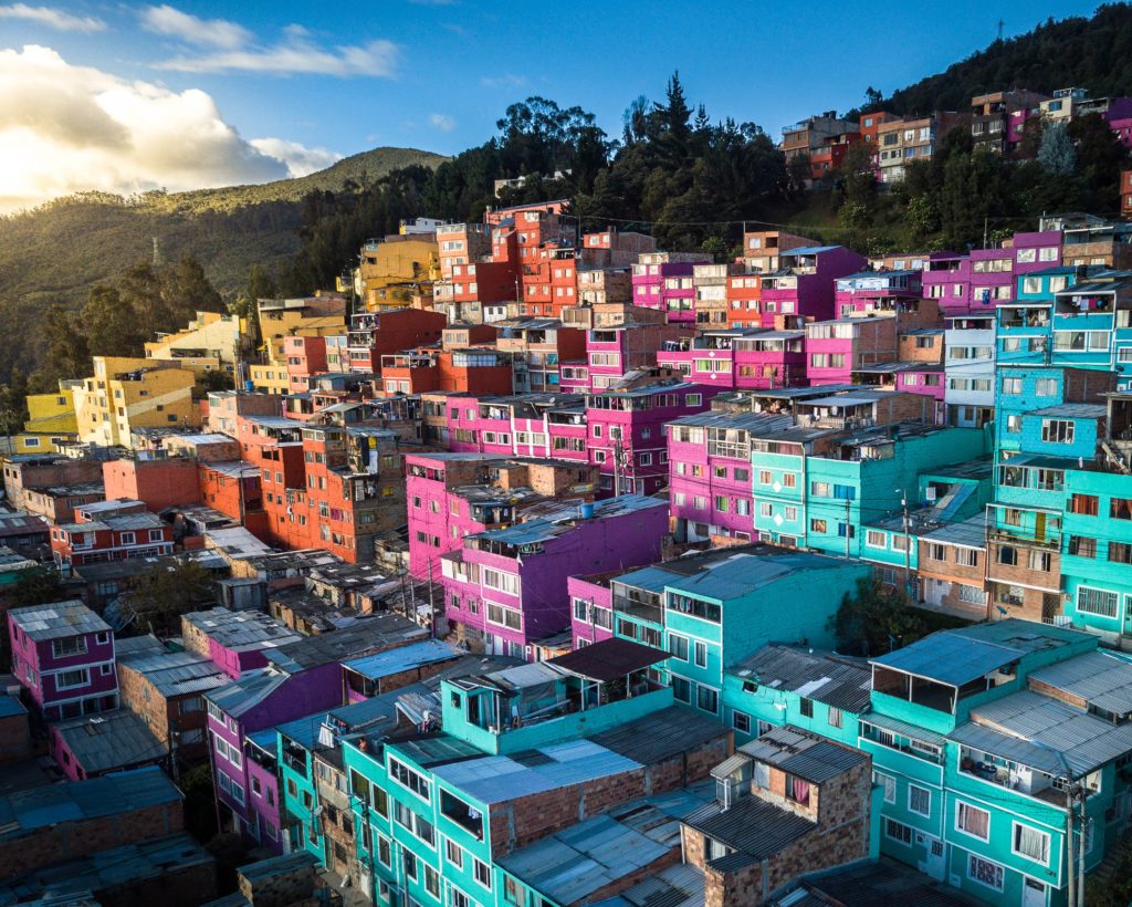 This image of a bright and colorful city in the side of a mountain in Colombia is featured in the Jaya Travel & Tours blog post called "Colombia Travel Guide"