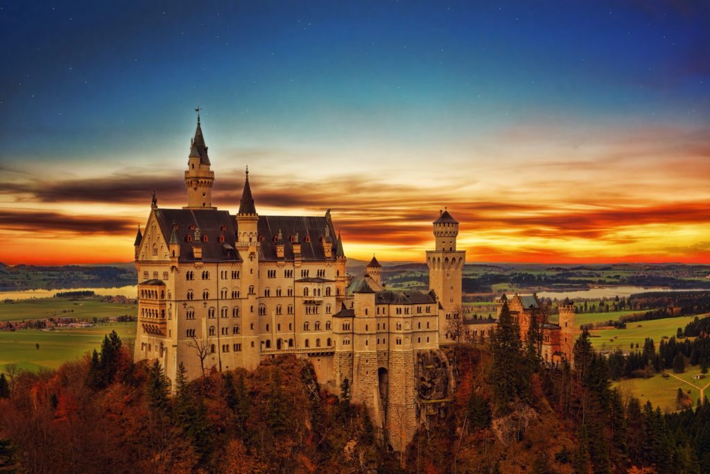 This landscape image of Neuschwanstein castle, a German architecture monument, is featured in Jaya Travel & Tours article, "Germany Travel Guide."
