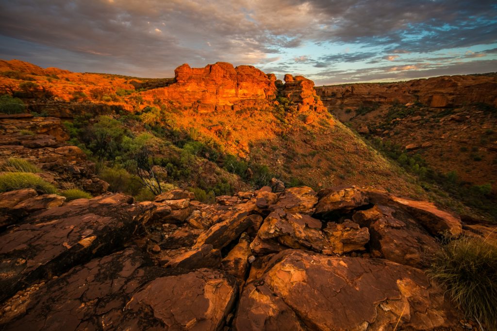 This landscape image of the desert in Australia with red rock formations is featured in the Jaya Travel & Tours blog post "Oceania Travel Guide"