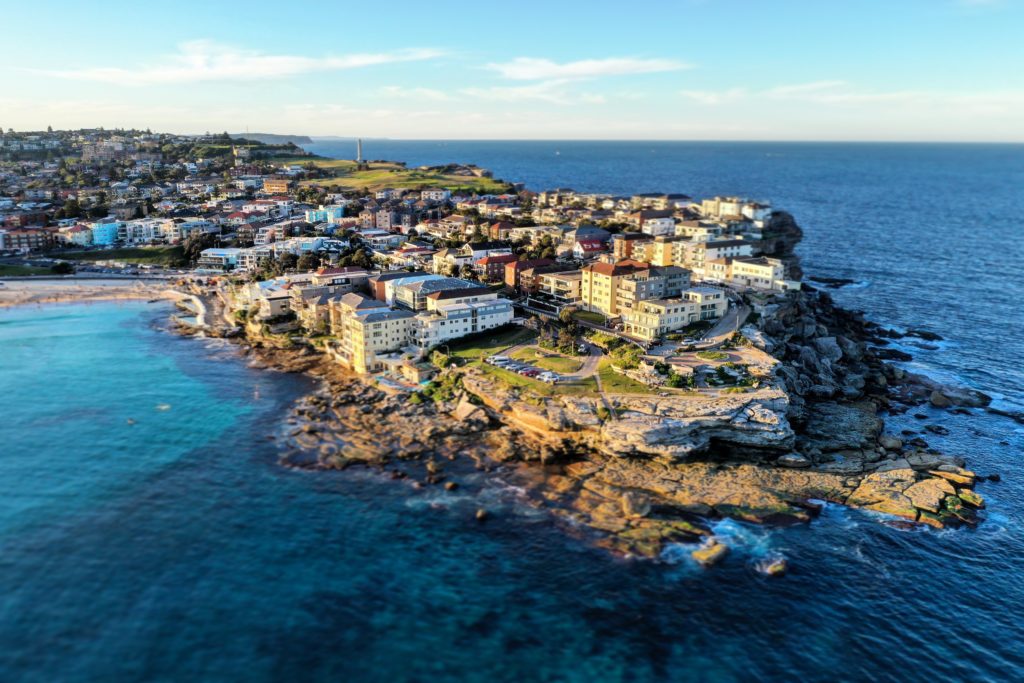 This image of a costal town on a peninsula with Bhondi Beach in Australia is featured in the Jaya Travel & Tours blog post "Oceania Travel Guide"