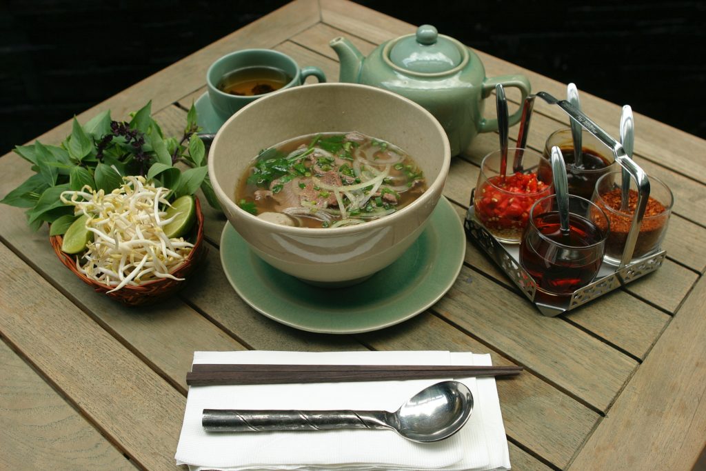 Featured in Korean Cuisine by Jaya Travel & Tours, this image shows a proper table setting in Korea with chopsticks and spoons.