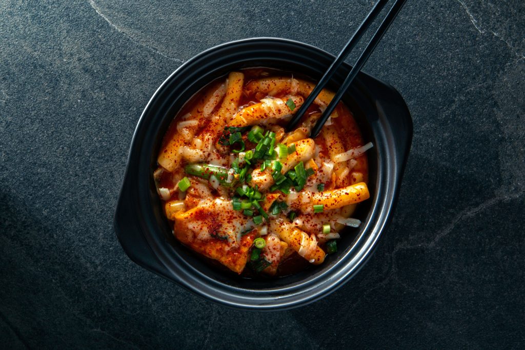 Featured in Korean Cuisine by Jaya Travel & Tours, this image shows a bowl of Korean food from Korea placed on a table.