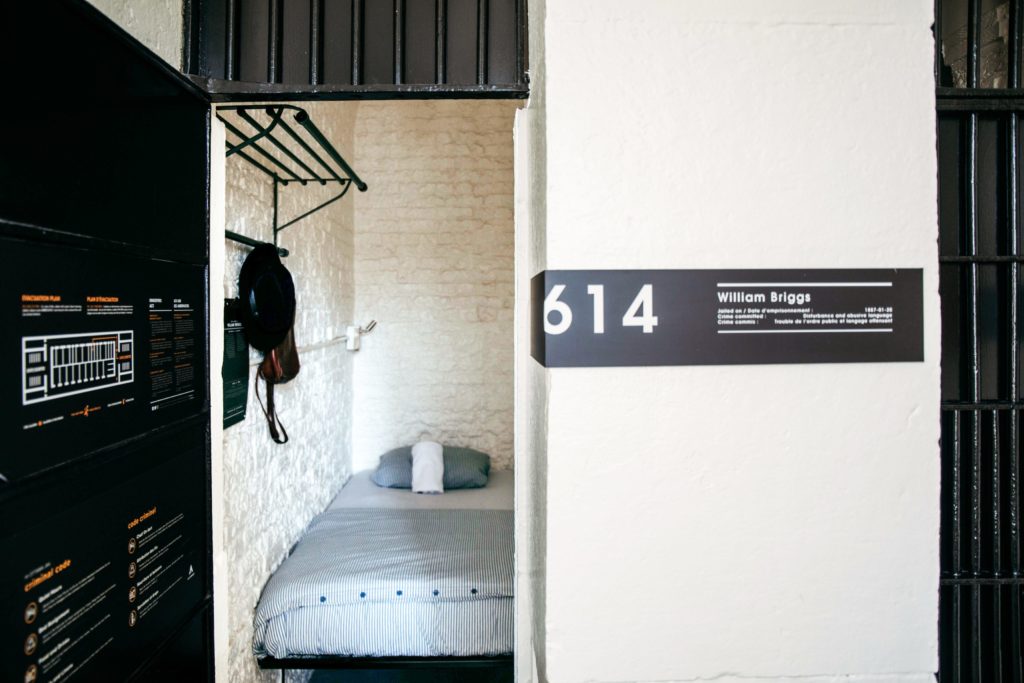 Featured in Unique Hotels Around the World by Jaya Travel & Tours, this image is of a prison cell in canada converted into a modern hostel room.