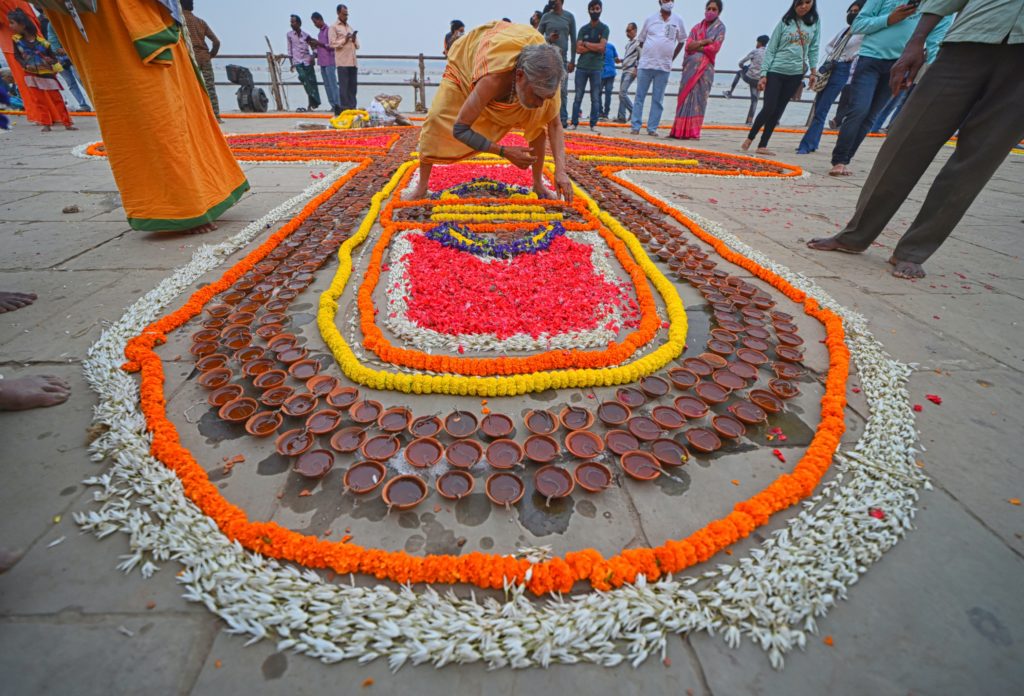Featured in How to Celebrate Diwali by Jaya Travel & Tours, this image shows a large display of diyas and flowers.