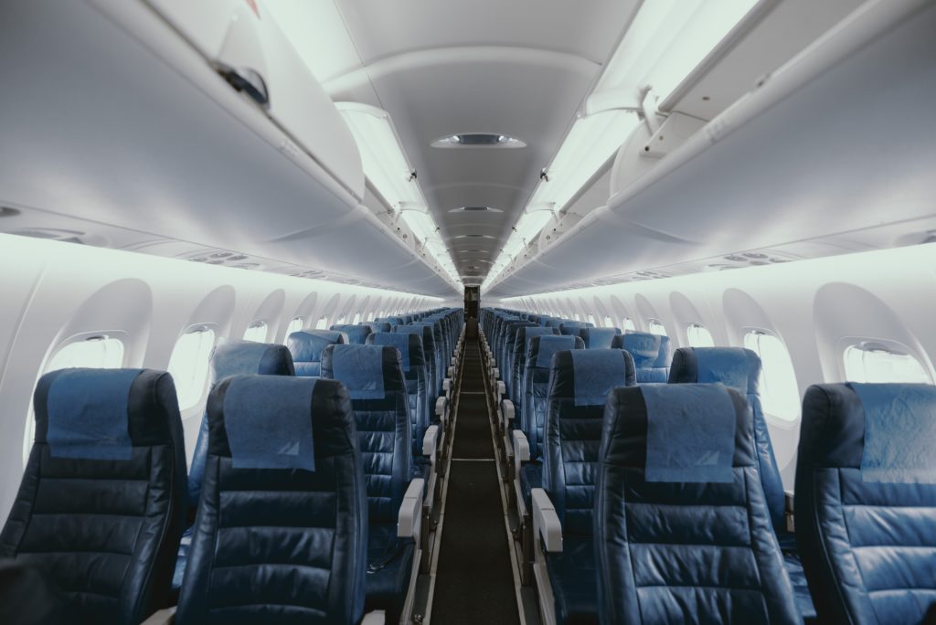 Featured in Guide to Flight Classes by Jaya Travel & Tours, this image shows an empty cabin in premium economy class.
