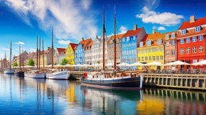 Nyhavn Port Exploring the Historic Canal and Heritage Destinati - Jaya Travel & Tours A colorful array of buildings bordering the water with several docked ships at the Nyhavn Port on this Jaya Travel & Tours Scandinavia Group Tour - Scandinavian Delights.
