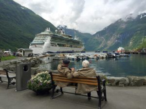 Top 5 Travel Destinations for Retirees blog- Picture of two elderly people looking at a cruise ship from the dock from Jaya Travel & Tours blog