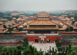 the-forbidden-city - Jaya Travel & Tours Aerial view of the Forbidden City in Beijing, with rows of orange-tiled roofs and red walls sprawling across the complex there.