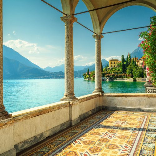 The beautiful landscape of Lake Como in Italy, photographed from the balcony of an opulent mansion in the coastal town of Varenna, which is featured in Jaya Travel & Tours customized tour enchanting Italy!