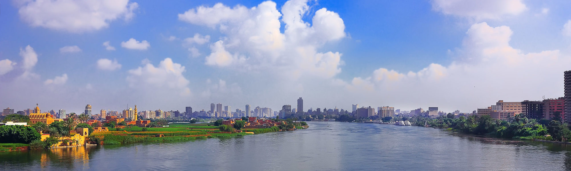 On a river cruise with Jaya Travel & Tours is the Nile river and the downtown of Cairo, Egypt on the horizon.